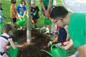 kids watering a tree(© 2019 David Shilamn)