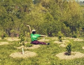 Danielle sitting among newly planted native trees