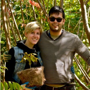 © 2017 Alan Li Man and woman smiling happily with tree ready for planting(© 2017 Alan Li)