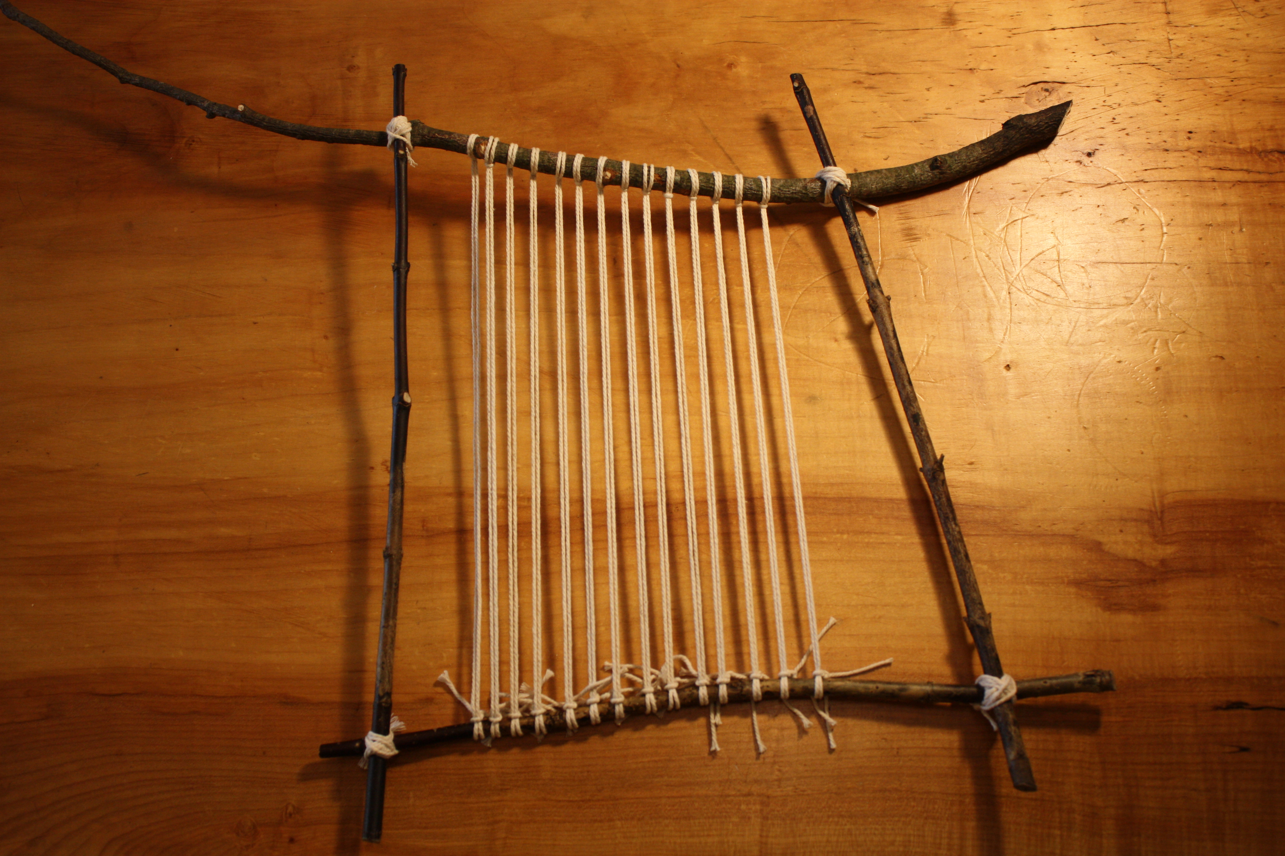 Completed warped loom with warp strings trimmed on the back.