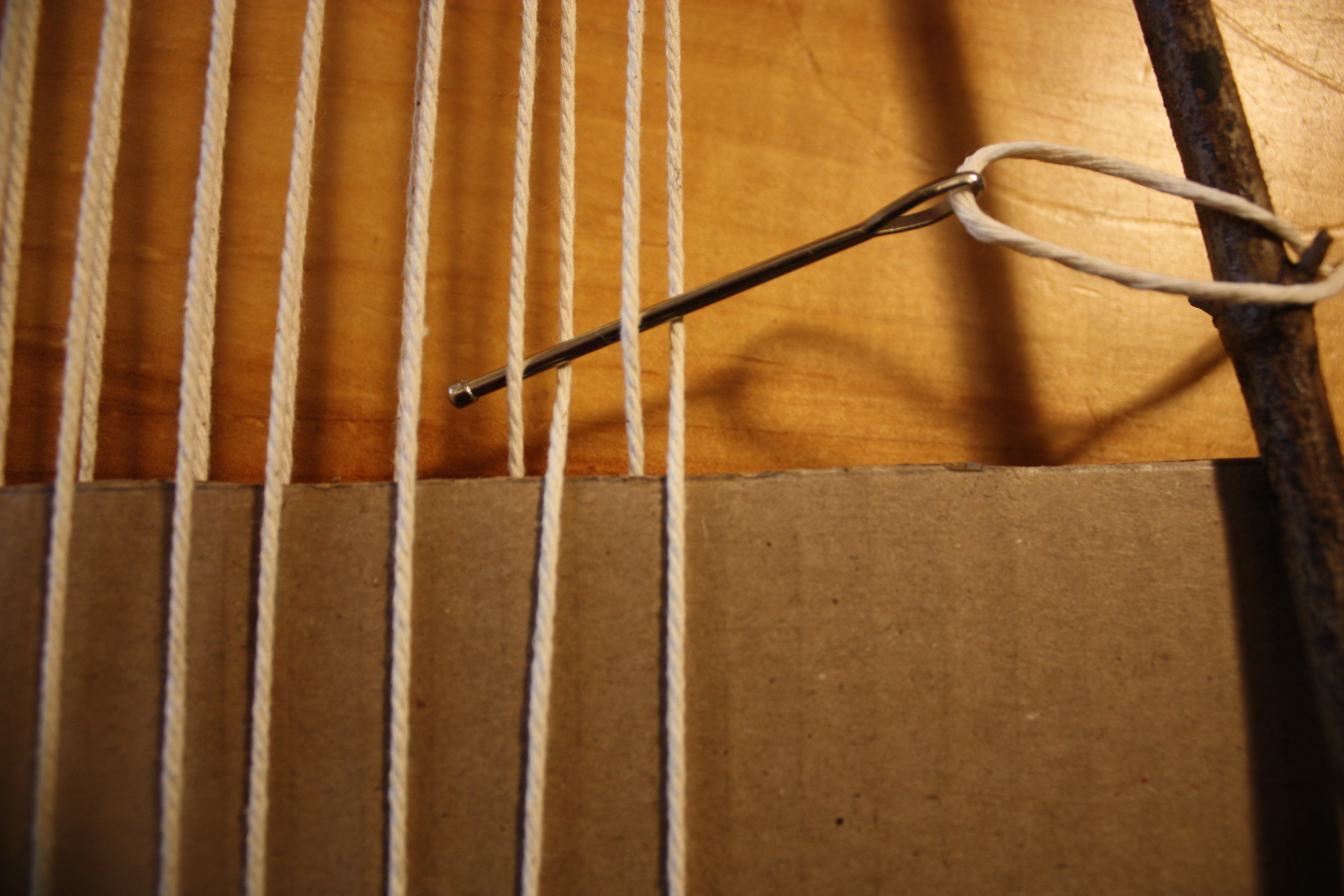 Starting the plain weave row, needle entering in the opposite pattern to the cardstock row. 