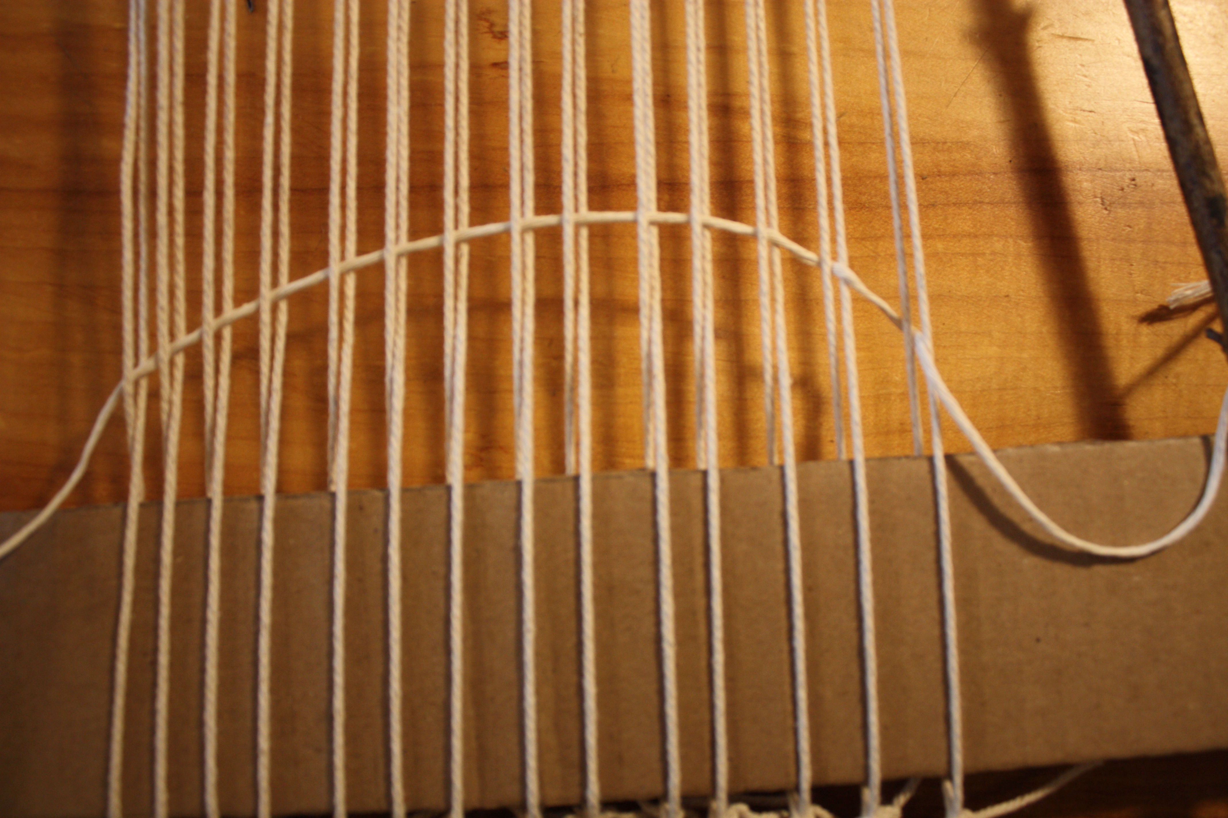 Row completed across the warp, showing alternating over-under pattern.