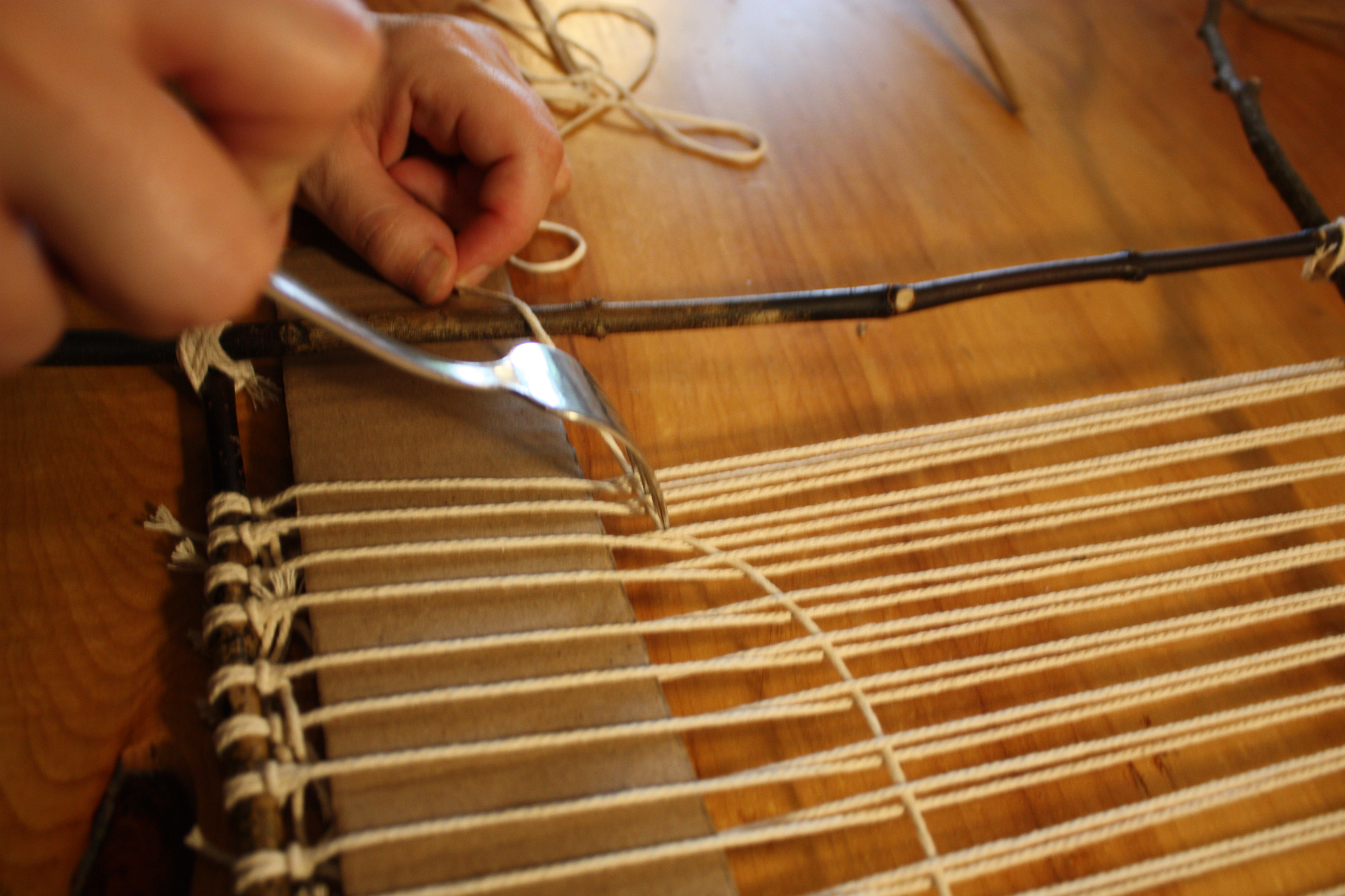 push down the weft string row tightly against the cardstock.