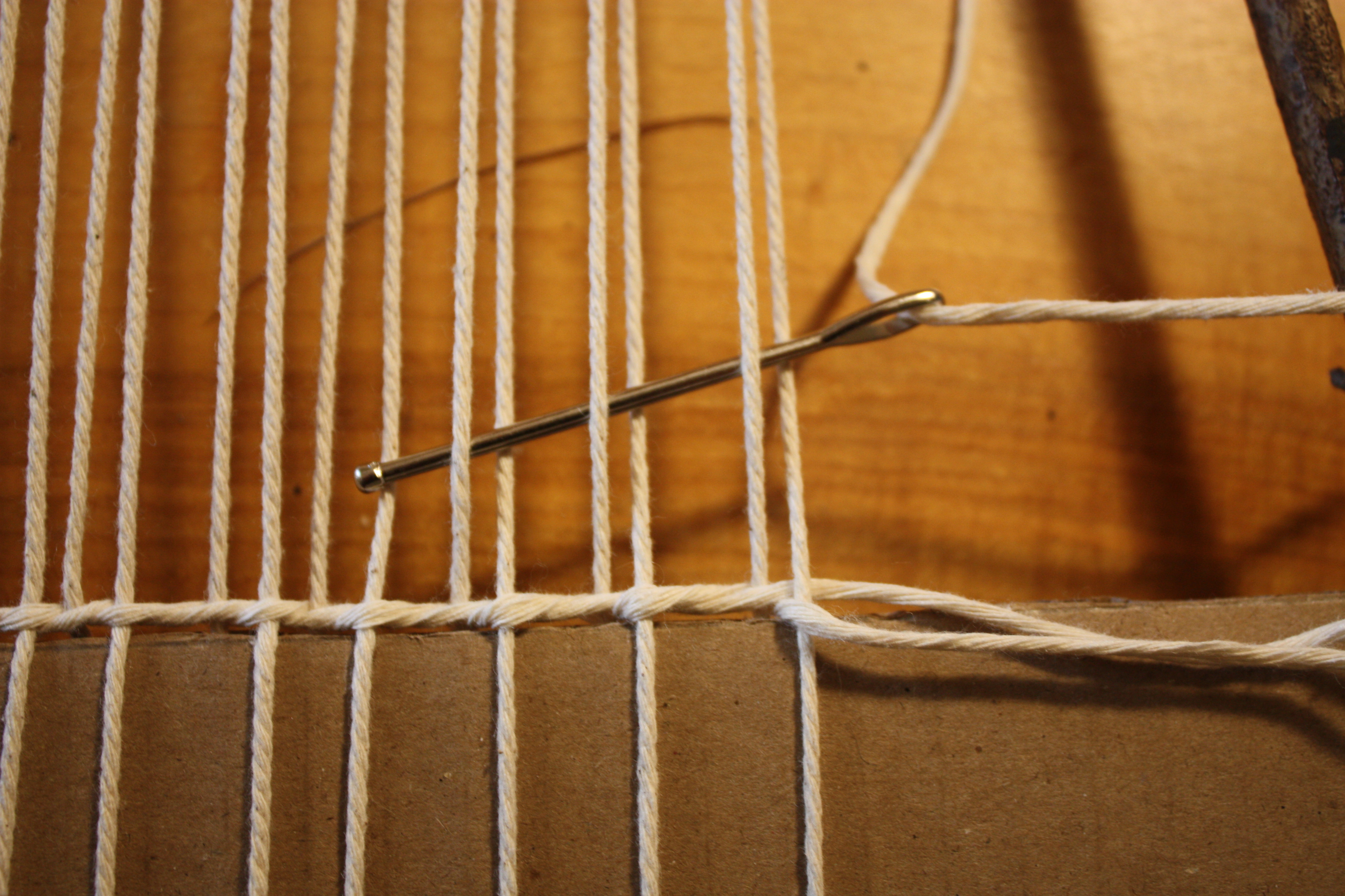 Transition back to plain weave rows above the twist row. 