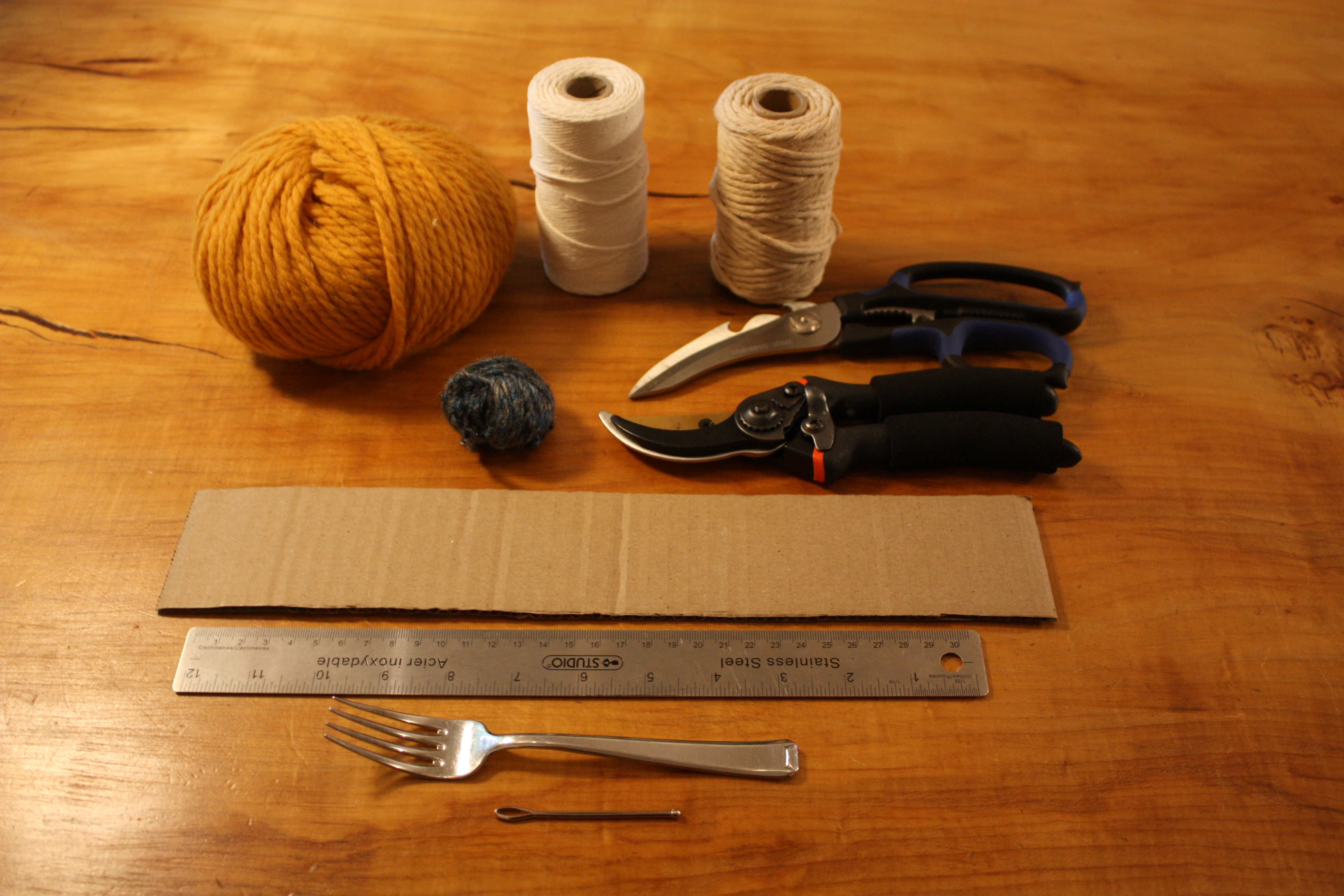 Craft materials used: yarn, scissors, wide needle, strong twine, pruners, ruler, cardstock
