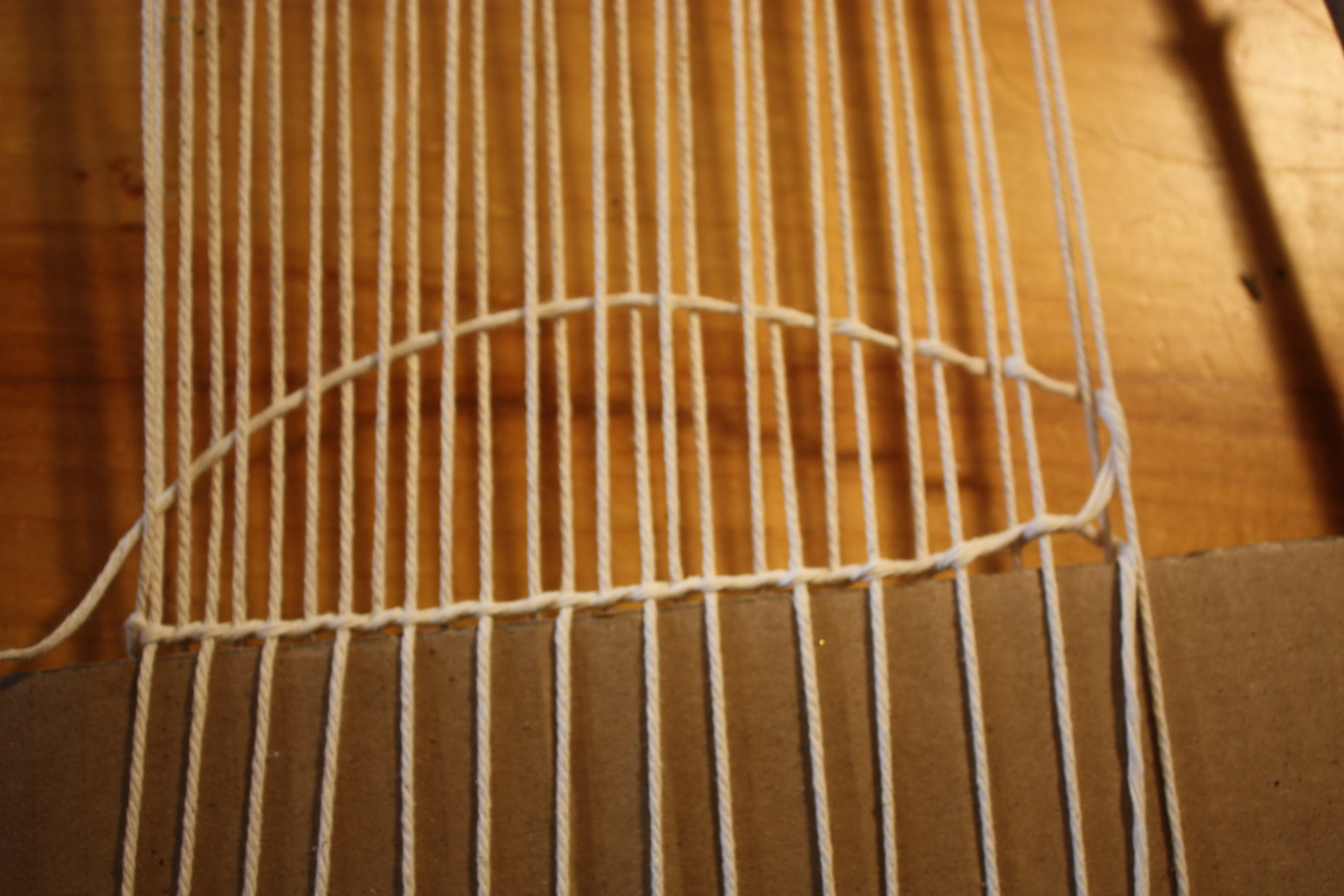  A completed weft row of plain weave after the twinning and twisting stitch, ready to be pushed down with a fork.
