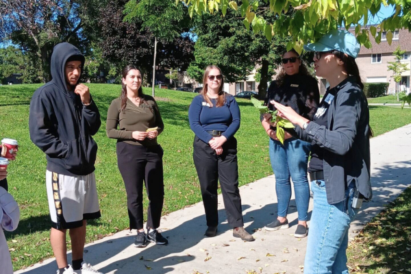 Keyondre listening to LEAF staff during a tree tour