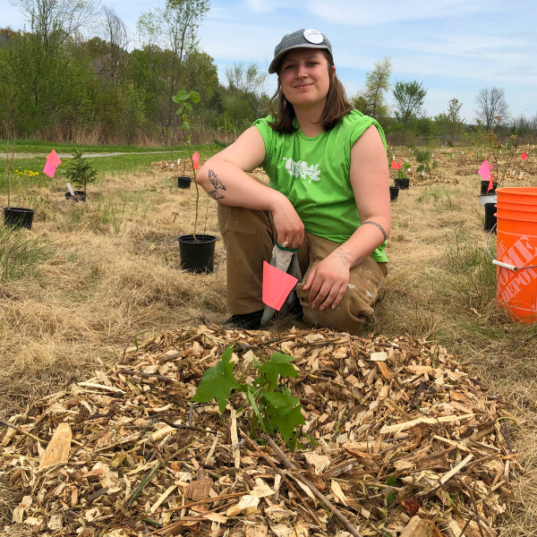 Jordyn planting a tree at Dean Plummer Park in King.