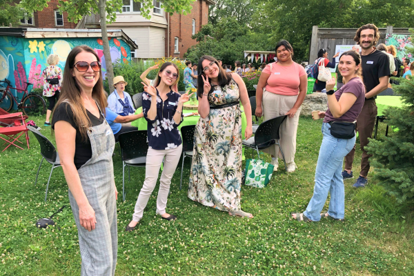 A group of LEAF staff and volunteers smiling at the camera at an outdoor garden party