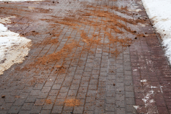 Sand applied to a paved surface in winter