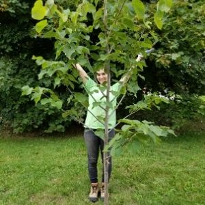 Woman with recently planted tree(© 2019 Brenna Anstett / LEAF)
