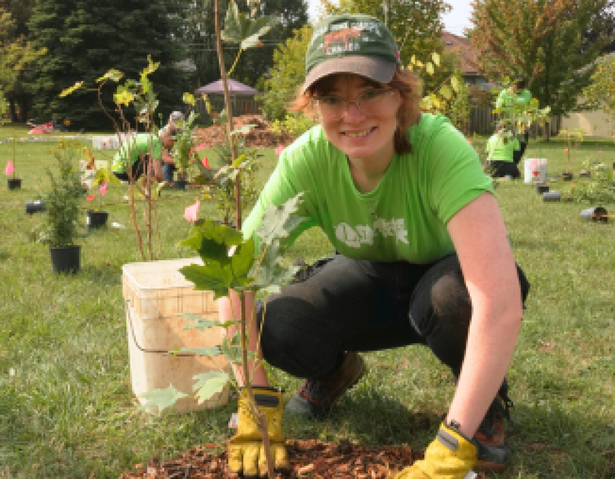 © 2025 Jordy Bouygoran / LEAF Elizabeth planting a sugar maple tree at a community planting event at Rosedale Park, Whitby.