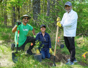 LEAF staff posing with community members at a community planting event