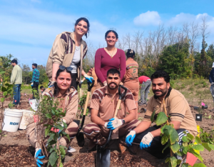 group of volunteers posing at a LEAF community planting event