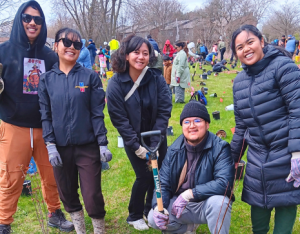 group of volunteers posing at a LEAF community planting event