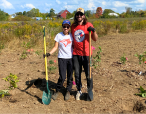 two volunteers posing at a LEAF community planting event
