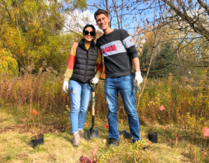 two volunteers posing at a LEAF community planting event
