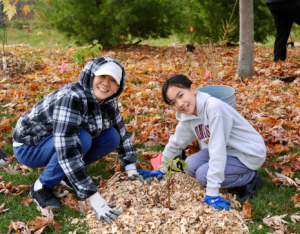 ©2025 Kennedy Paul Two participants at a LEAF planting event