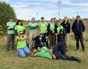 group of volunteers posing at a LEAF community planting event