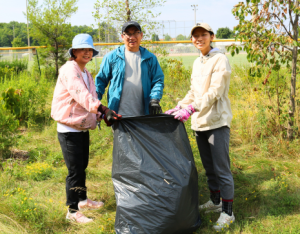 A family of three participating at a LEAF stewardship event