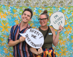 LEAF staff members holding fun signs at LEAF garden party