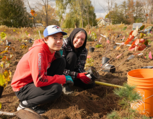 Two participants at a LEAF planting event