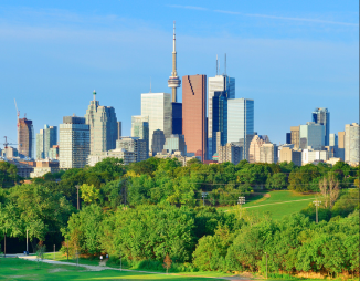 © 2025 LEAF via Canva.com Toronto skyline in background with urban forest and park in foreground