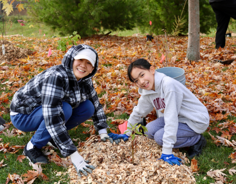 ©2025 Kennedy Paul Two participants at a LEAF planting event