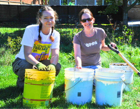 © 2026 / LEAF two LEAF staff members posing with buckets of mulch