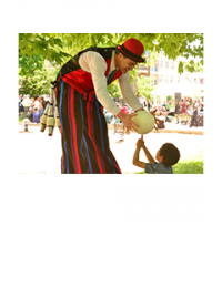 © 2018 David Slaughter / LEAF Clown handing a boy a balloon under the canopy of a leafy, lush tree