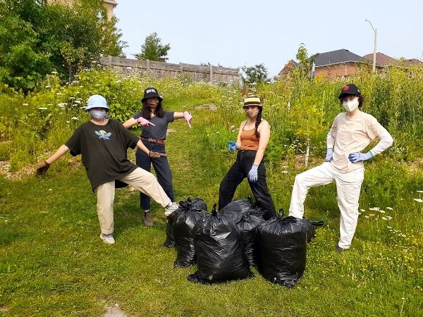 Volunteers with bags of invasive plants